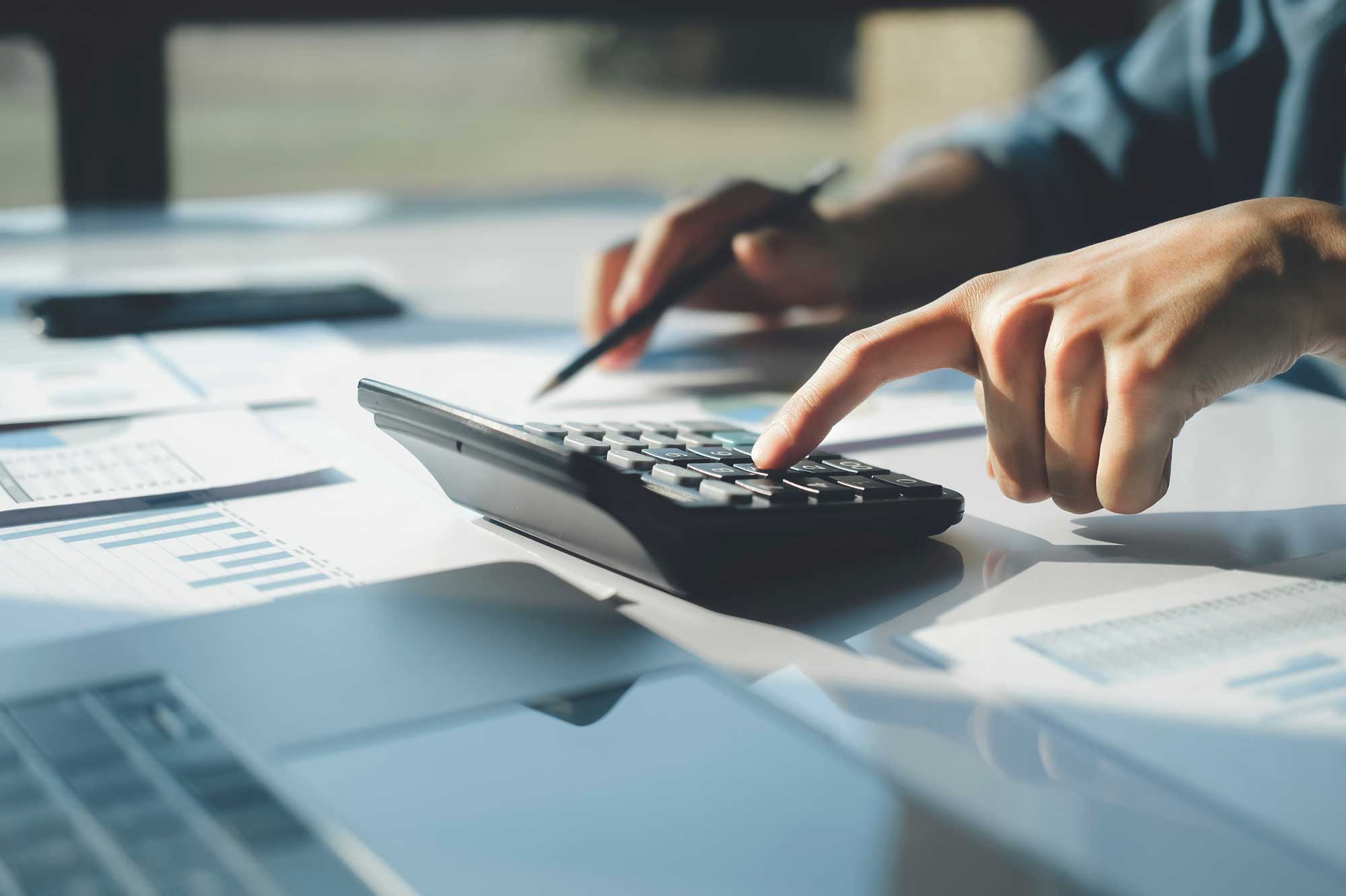 accountant-using-calculator-for-calculate-finance-report-in-office