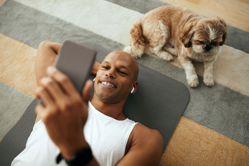 Young man laying on his back looking at the phone