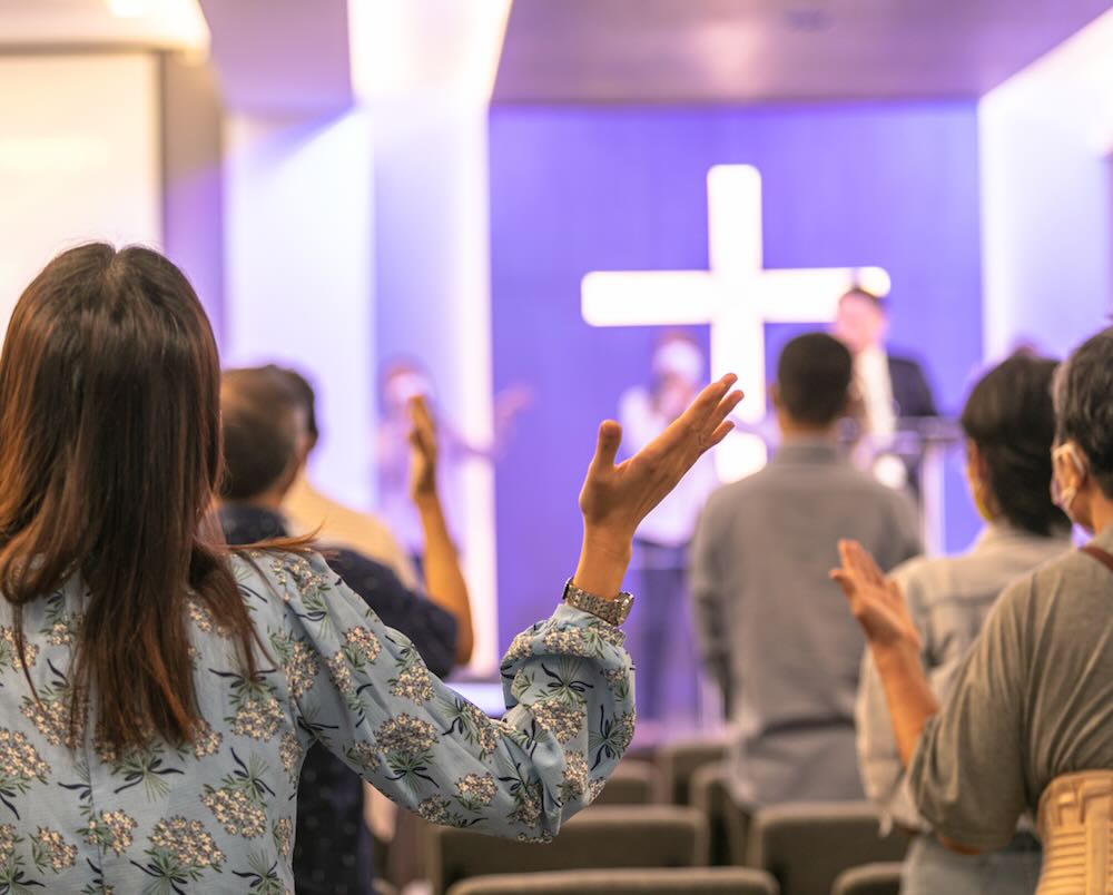 Raising hands to worship Jesus in the church