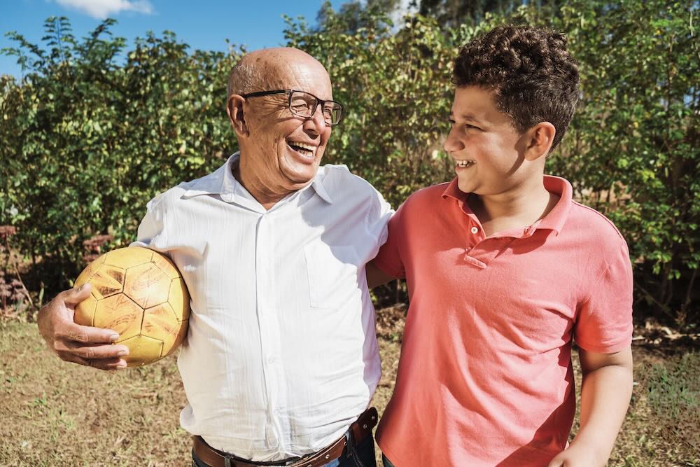 Grandfather smiling looking at his grandson